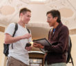 Sean Unger ’18 (left) and David Galindo ’18 look at the app they built for the Redlands Area Historical Society, which easily identifies buildings with historic designations. (Photo by Coco McKown '04, '10)